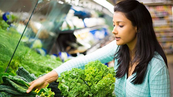 Woman looking at produce in market