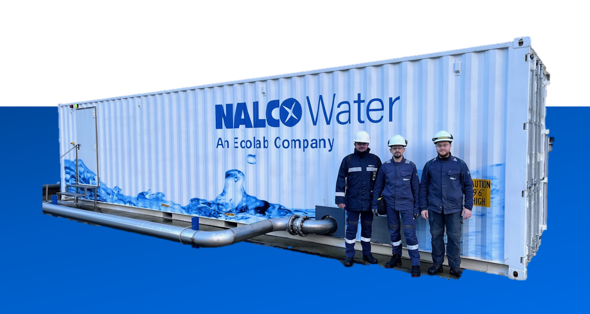 Three Ecolab colleagues standing next to a modular Ecolab / Nalco Water equipment container