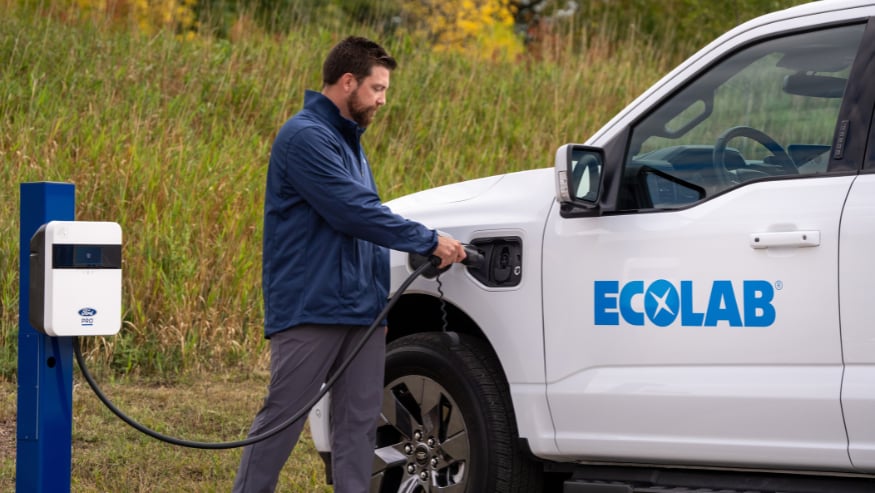 An Ecolab associate charges a Ford F-150 Lightning Pro