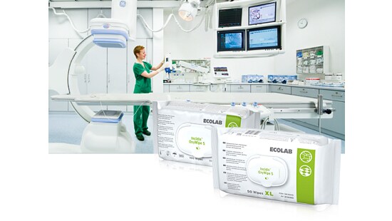 Modern operating room with a healthcare professional adjusting equipment, and two packages of Ecolab Incidin OxyWipe S disinfectant wipes in the foreground.